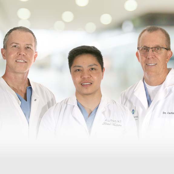 Dr. Carlson, Dr. Le, and Dr. Murray smiling